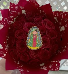 a close up of a red flower with a sticker on the center and an image of a woman's face