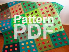 a colorful quilt with the words pattern pdf on it in front of a wooden floor