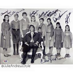 an old black and white photo of a man sitting on a chair in front of a group of children