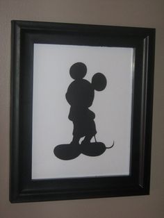 a shadow of mickey mouse in a black frame