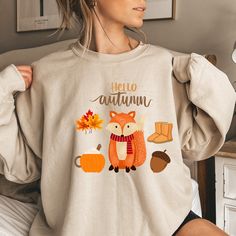 This sweatshirt is so pretty. The pretty fall themed sweatshirt definitely lets you know that fall is on the way. The boots, latte, leaves, and fox are great symbols for the upcoming season.  This sweatshirt is very soft and comfortable and is sure to keep you warm. The collar is ribbed knit, so it retains its shape even after washing. There are no itchy side seams on these sweaters. *50% cotton, 50% polyester * Medium-heavy fabric * Loose fit * Sewn-in label *Runs true to size If you would like Cute Long Sleeve Fall Sweatshirt, Cute Long Sleeve Sweatshirt For Fall, Cute Letter Print Sweatshirt For Fall, Cute Fall Letter Print Sweatshirt, Cute Fall T-shirt, Cute Graphic Print Sweater For Fall, Cute Fall Sweater, Leaves Shirt, Cute Sweaters For Fall