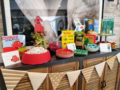 a display in a store window filled with lots of items and decorations on top of a wooden cabinet