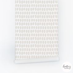 a white and beige wallpaper with circles on it