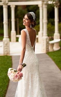 a woman in a wedding dress holding a bouquet