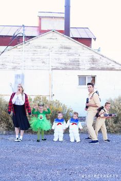 a group of people dressed up in costumes standing next to each other near a building