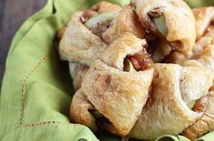 several pastries sitting on top of a green cloth