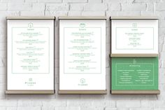 three framed menus on a brick wall