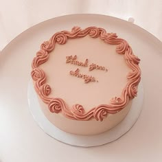 a pink frosted cake with the words thank you always written in it on a white plate