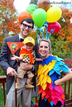 a man and woman are dressed up in costumes with balloons on their heads for halloween