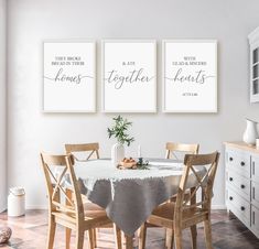 a dining room table with chairs and two posters on the wall above it that say together