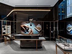 a room filled with lots of glass cases and tables covered in gold chains, watches and jewelry