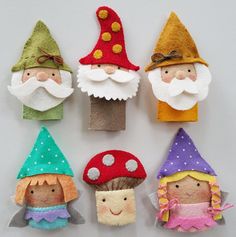 six gnomes made out of felt sitting next to each other