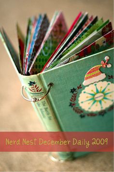 there is a small book that has been decorated with christmas images on it and the words nerd nest december daily 2009