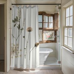 a bathroom with a shower curtain decorated with wildflowers and other flowers on it