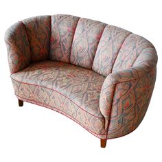 an upholstered couch with red and blue patterns