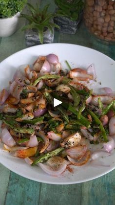 a white bowl filled with vegetables on top of a wooden table