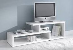 a white entertainment center with a tv on top of it and books in the bottom shelf