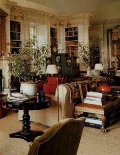 a living room filled with furniture and lots of books on top of it's shelves