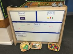 a white board with writing on it next to baskets filled with toys