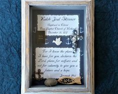 an old frame holds a poem in the shape of a cross and two seashells