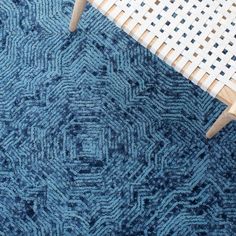 a blue rug on the floor next to a chair