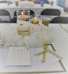 the table is set with candles and napkins