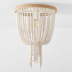 a white beaded chandelier hanging from the ceiling