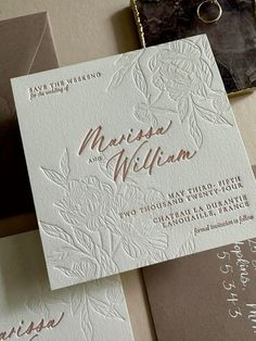 the wedding stationery is laid out on top of each other, including an envelope