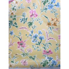 a yellow floral wallpaper with pink, blue and green flowers on it's side