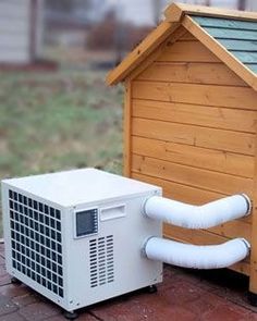 an air conditioner sitting next to a dog house