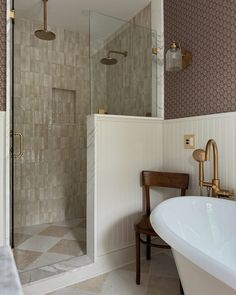 a bathroom with a bathtub, sink and shower stall in it's corner