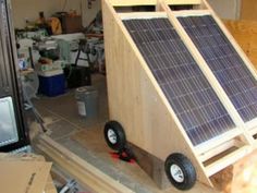 a solar powered device is sitting on the floor in a room filled with boxes and other items