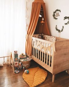 a baby's room with a crib, bed and toys on the floor