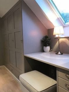 a white sink sitting under a window next to a green frame in a room with wooden floors