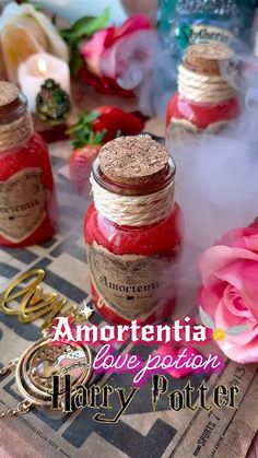 there are two jars with jams in them on the table next to flowers and candles