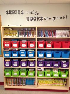 a book shelf filled with lots of books and plastic bins next to a wall