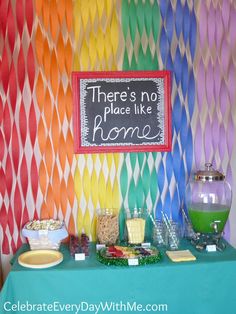 there's no place like home at this birthday party with colorful paper streamers on the wall