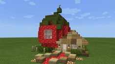 a house made out of strawberries in the middle of a field with grass and rocks