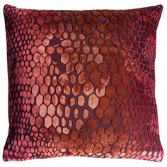 a red and brown pillow with an animal print pattern on it's back side