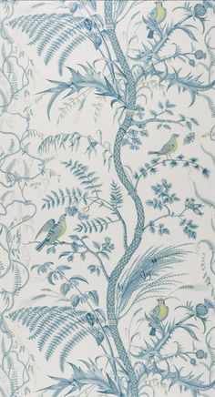 a blue and white wallpaper with birds in the tree on it's side