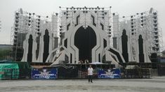 a man standing in front of a stage with scaffolding on it