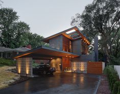 a car is parked in front of a modern house