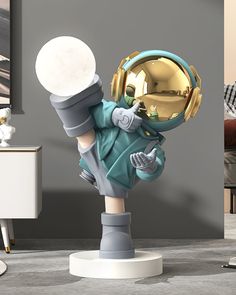 a small statue of an astronaut is posed in front of a living room with grey walls