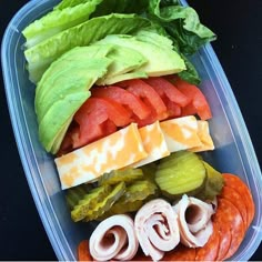 a plastic container filled with lots of different types of food on top of each other