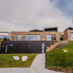 A house on sloped site with large windows in stone walls Interior Photoshoot, Cornwall House, Glass Doors Patio, Gorgeous Interiors