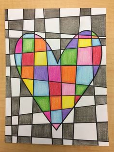 a heart made out of colored squares on a piece of paper with the word love written in it