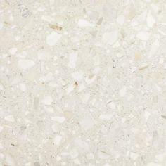 a white marble floor with small rocks on it