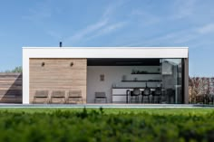 a modern house with an open patio and dining area