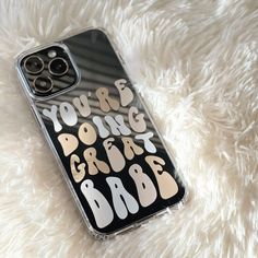 an iphone case with the words you're doing great in black and gold on it