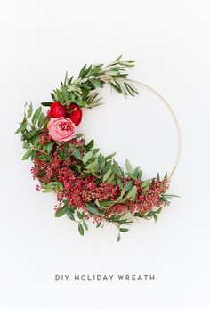 a wreath with flowers and greenery on it